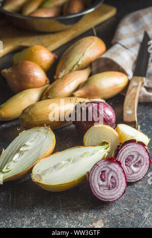 Halved fresh bulbs on old kitchen table. Stock Photo