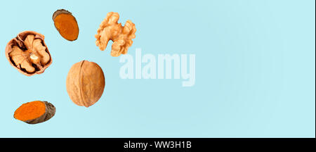 Composition with walnuts and turmeric on color background, top view Stock Photo