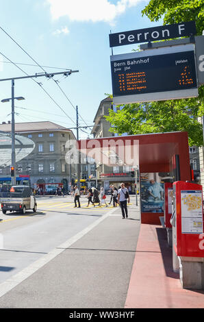 Bern, Switzerland - August 14, 2019: Bus station by the main train station in the center of the Swiss capital. Public transport. People on the street. Cars on the road. Intersection. Daily life. Stock Photo