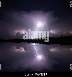 A lightning strike lights up the sky and is reflected in a lake at Everglades National Park in Florida.