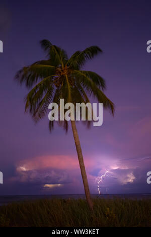 Lightning strikes offshore during a night thunderstorm at Fort Lauderdale Beach. Stock Photo