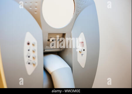 Close-up detail of hairdryer hanged on the wall of bathroom in modern hotel with power plug for the razor machine Stock Photo