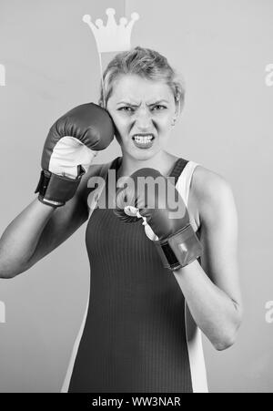 VIP gym. Fighting queen. Woman boxing glove and crown symbol of princess. Queen of sport. Become best in boxing sport. Feminine tender blonde with queen crown wear boxing gloves. Fight for success. Stock Photo