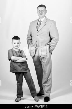 business partner. small boy doctor with dad businessman. childhood. trust and values. fathers day. family day. father and son in business suit. male fashion. happy child with father. We are family. Stock Photo