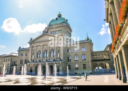 Bern, Switzerland - August 14, 2019: Building of the Swiss Parliament photographed from outside with people walking on the adjacent square. Government, administration. Switzerland confederation. Stock Photo