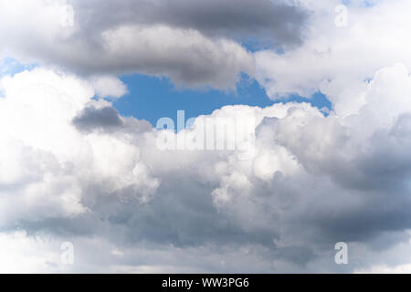Cumulus clouds are often described as "puffy", "cotton-like" or "fluffy" in appearance. Their name derives from the cumulus-, meaning heap or pile Stock Photo