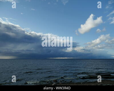 low dark rain clouds over the sea Stock Photo
