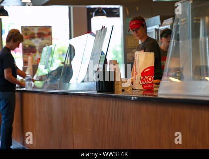 Storrs, CT USA. Aug 2019. Fast food take out bag ready for customer pickup at the restaurant counter. Stock Photo