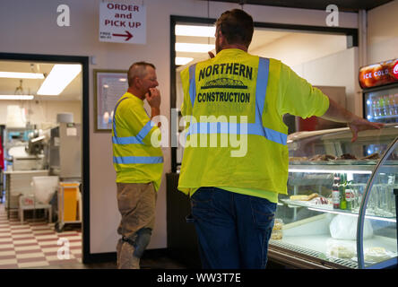 Rocky Hill, CT USA. Aug 2019. Hungry construction workers with reflective safety vests getting some lunch from a favorite local eatery. Stock Photo