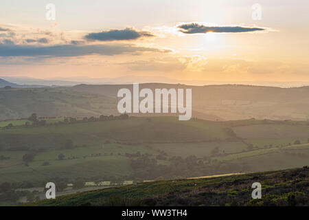 Sunset clouds over rolling farming fields in United Kingdom Stock Photo