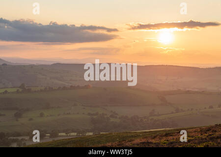 Setting sun over rolling hills in Shropshire, United Kingdom Stock Photo