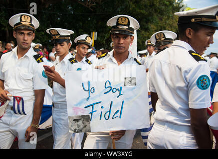 Young military personal hold a sign honoring Fidel Castro during the funeral to Fidel in Havana, Cuba Stock Photo