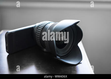 Concept of large lens attached to smartphone Stock Photo