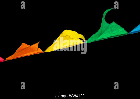 Colorful triangles flags ornament for carnival and holiday hang on a rope and flutter in the wind outdoors, isolated on a black background by clipping Stock Photo
