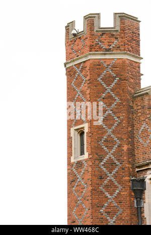 Hampton Court Palace isolated tower with window and diamond patter of white bricks against the red brick. Copy space on left. Stock Photo