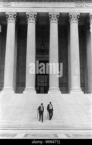 Equal Justice Under Law is a phrase engraved on the front of the United States Supreme Court building in Washington. Two identical preppy dressed stylish men with rolled umbrellas 1969 Washington DC 1960s US. USA HOMER SYKES Stock Photo