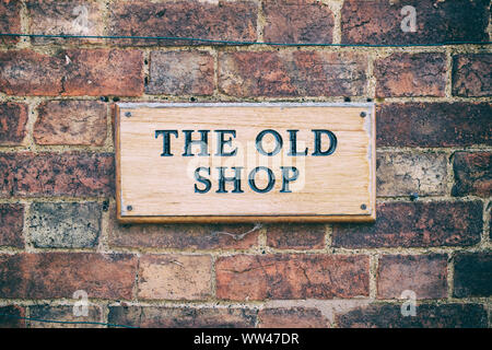 The old shop sign on a brick cottage wall. Little Comberton , Cotswolds, Wychavon district, Worcestershire, UK. Vintage filter applied Stock Photo