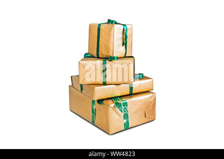 Holiday gift boxes decorated with ribbon isolated on white background. four large boxes wrapped in shiny gold gift paper. Beautiful gifts for Christma Stock Photo