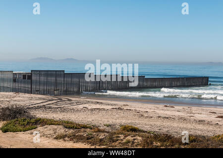 Border Field State Park beach with the international border fence between Tijuana, Mexico and San Diego, California. Stock Photo