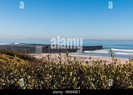 Border Field State Park beach with the international border wall separating Tijuana, Mexico from San Diego, California Stock Photo