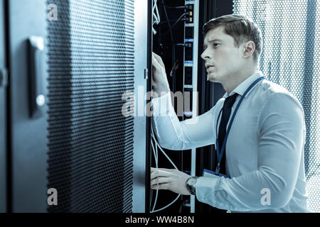 New tall detective in a blue shirt looking attentive Stock Photo