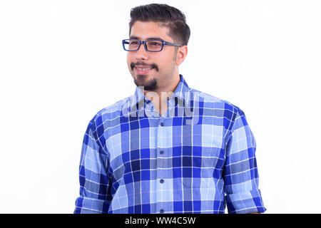 Happy bearded Persian hipster man with eyeglasses thinking Stock Photo