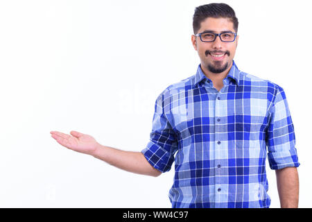 Happy bearded Persian hipster man showing something Stock Photo