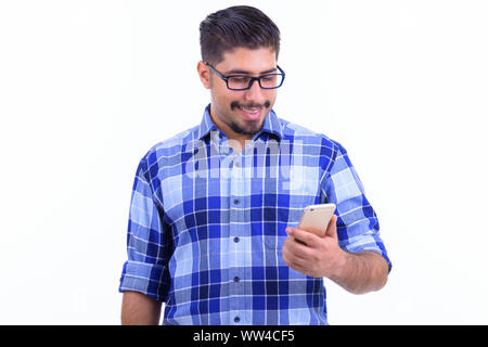 Happy bearded Persian hipster man using phone Stock Photo