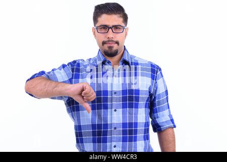 Stressed bearded Persian hipster man giving thumbs down Stock Photo