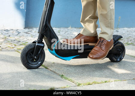 Young Man Riding An Electric Kick Scooter Stock Photo