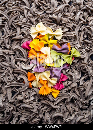 Closeup of italian farfalle colorful bows, and whole grain pasta Stock Photo