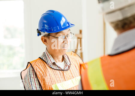 Happy professional worker working together home builder architecture mix race in construction site Stock Photo