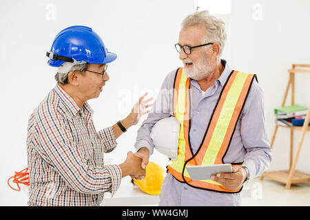 Happy professional worker working together home builder architecture mix race in construction site Stock Photo