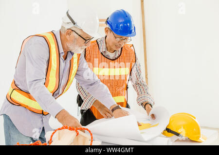 Happy professional worker working together home builder architecture mix race in construction site Stock Photo