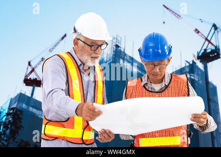 professional senior Engineer at construction site working together mix race with Asian elder Stock Photo