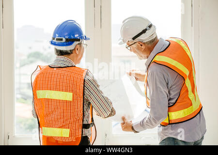 Happy professional worker working together home builder architecture mix race in construction site Stock Photo