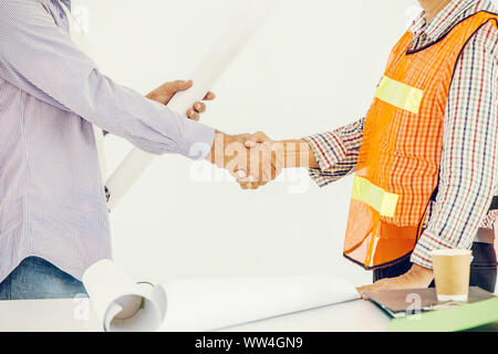 worker shaking hand deal job working together builder and designer Stock Photo