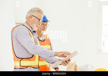 Happy professional worker working together home builder architecture mix race in construction site Stock Photo