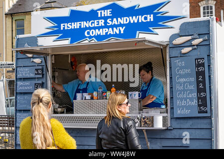 Two ladies queuing up to buy a fish finger sandwich from a mobile food stall at the Great Yarmouth Maritime Festival Stock Photo