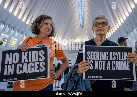 New York, USA. 12th Sep, 2019. Members of the activist group Resist gathered a silent protest inside The Oculus holding No Raids/Close The Camps/Abolish ICE banners, photographs of the children who have died in ICE custody, and photographs of the detention camps to object to Border Patrol and ICE treatment of immigrants, refugees, and asylum seekers. Credit: Erik McGregor/ZUMA Wire/Alamy Live News