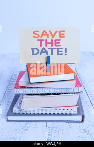 Conceptual hand writing showing Save The Date. Concept meaning reserve the mentioned future wedding date on their calendar pile stacked books notebook Stock Photo