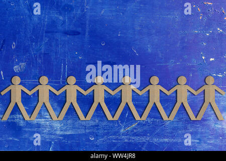Teamwork concept, group of people paper cut out on blue vintage background with copy space Stock Photo