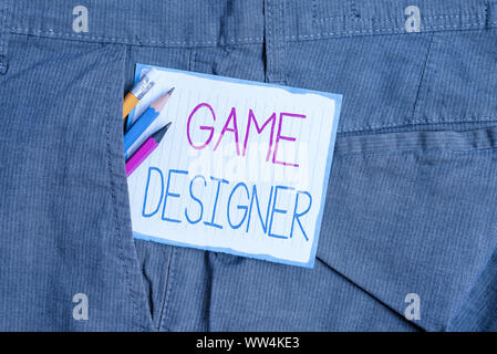Handwriting text Game Designer. Conceptual photo Campaigner Pixel Scripting Programmers Consoles 3D Graphics Writing equipment and white note paper in Stock Photo