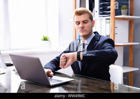 Efficient Businessman Looking At Watch Checking Time Stock Photo
