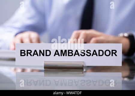Male Hand Typing On Keyboard With Brand Ambassador Text Sign In Front Stock Photo