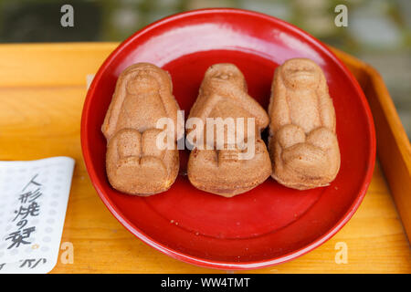 Nikko Japan. One of local specialities,'Ningyoyaki' is a sweets made of sponge filled with sweet bean paste in th the shape of three wise monkeys. Stock Photo