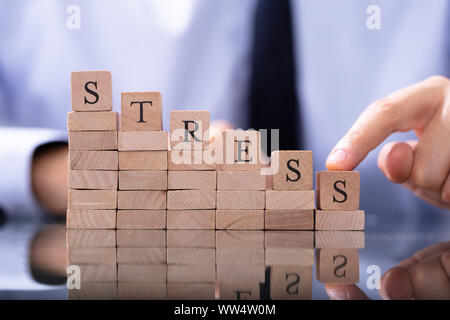 Reduce Stress Concept. Wooden Blocks In Declining Chart Stock Photo