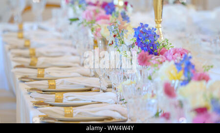 Catering table set service with silverware, napkin and glass at restaurant before party Stock Photo