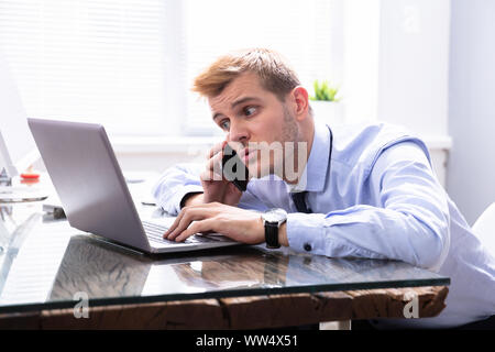 Concentrated Businessman Working On Computer In Office Stock Photo