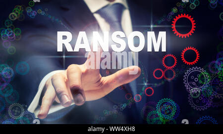 A businessman pressing a Ransom business concept on a graphical display of cogs Stock Photo
